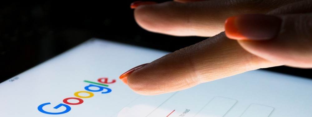 Woman's finger using Google on a smart phone